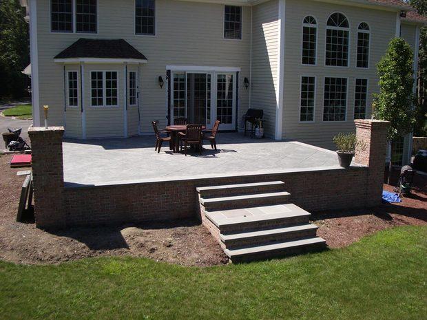 Colonial Deck In Exeter Sliding Gl Door Yellow Lap Siding By Colonial Deck With Raised Concrete Red Brick Exterior