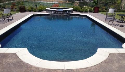 Traditional Pool with stamped concrete patio