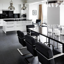 Modern Kitchen with black upholstered dining chairs with chrome arm rests