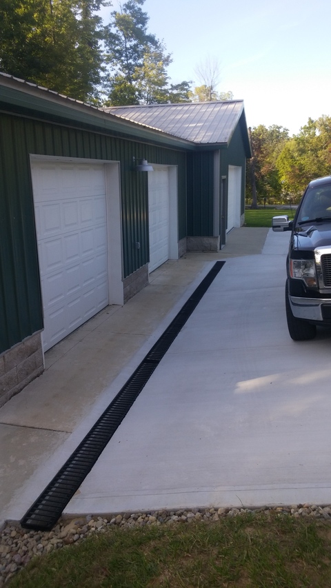 Transitional Garage with cement paved driveway