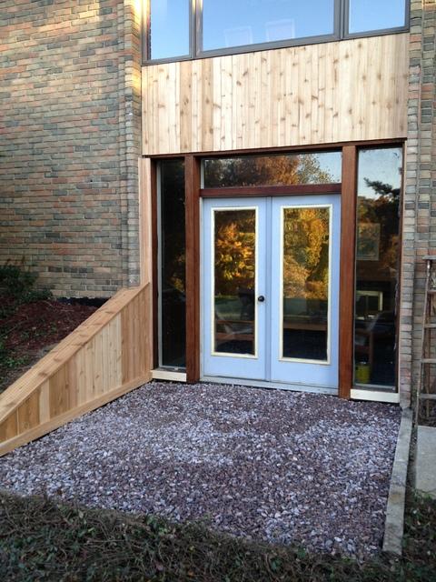 Transitional Home Exterior with large glass panel front doors