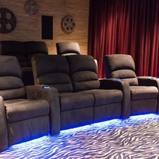 Eclectic Home Theater with stacked stone accent wall