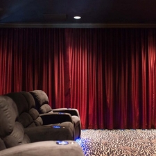 Eclectic Home Theater with unique carpet pattern