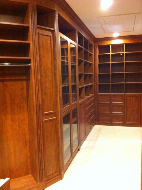 Traditional Closet with glass front cabinet doors