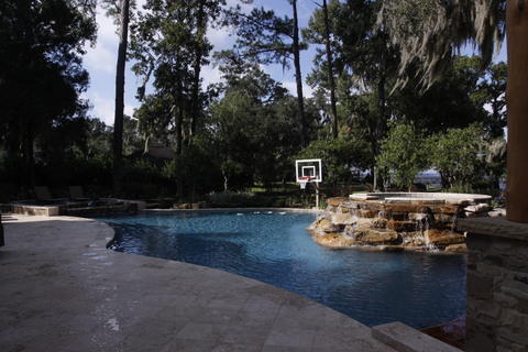 Modern Pool with travertine tile pool coping