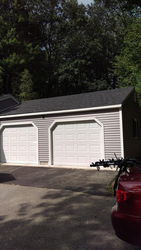 Transitional Garage with white garage dooes