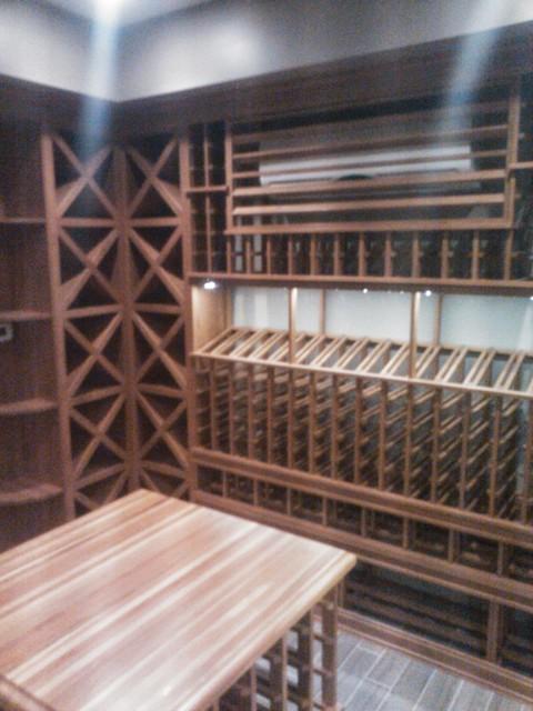Contemporary Wine Cellar with wood top table with wine rack below