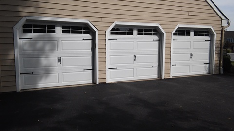 Transitional Garage with white panel garage doors
