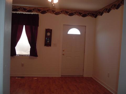 Casual / Comfortable Entry with arched window in exterior door