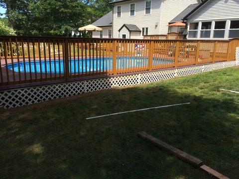 Transitional Pool with stained wood handrail and balusters