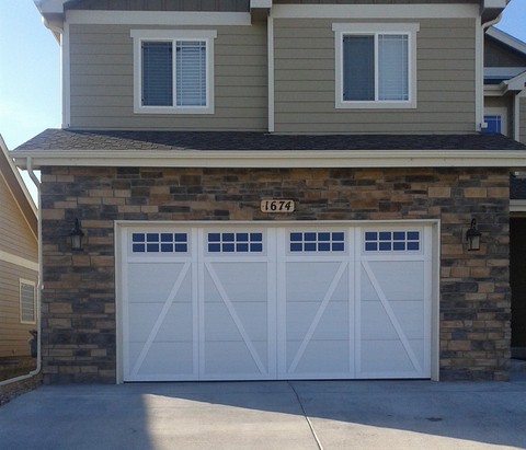 Transitional Garage with black exterior sconce light