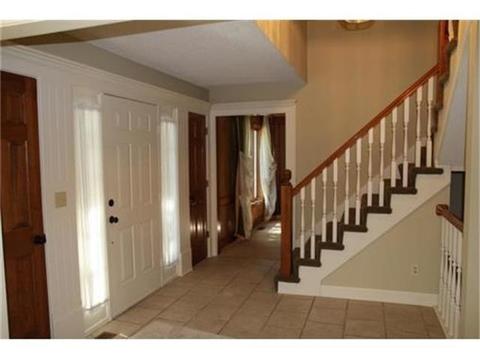 Transitional Entry with white wood stair skirt board