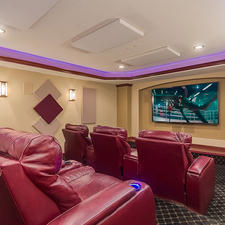 Eclectic Home Theater with beige wall paint and sound panels