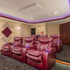 Eclectic Home Theater with red leather theater seats