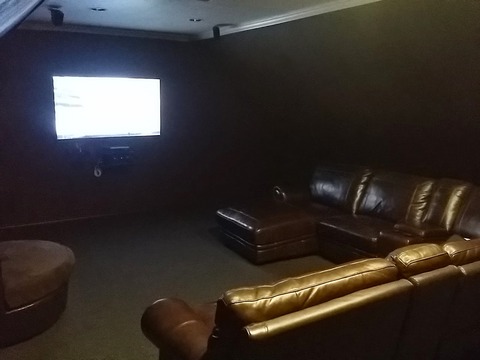 Traditional Home Theater with dark brown painted walls