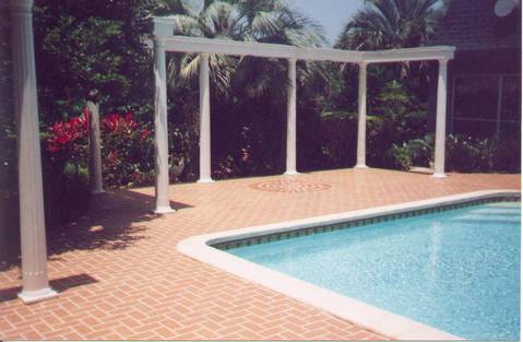Traditional Pool with red brick patio