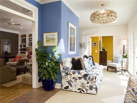 Eclectic Living Room with yellow painted accent wall