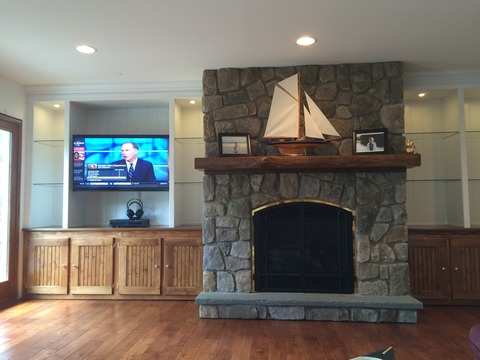 Rustic Home Theater with built in cabinets flanking fireplace