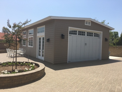 Transitional Garage with raised circular flower bed
