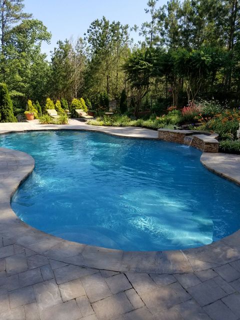 Traditional Pool with cobblestone patio