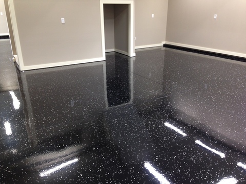 Transitional Garage with black chipped epoxy flooring
