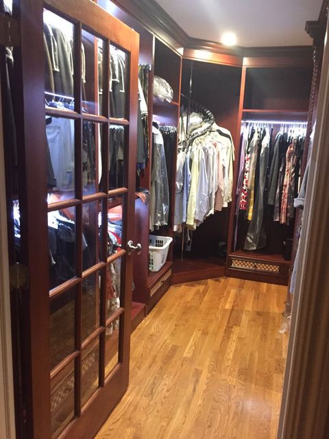 Traditional Closet with dark stained custom closet cabinets