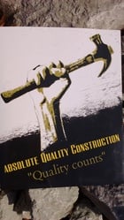 Absolute Quality Construction logo