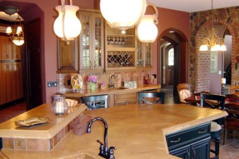 Traditional Kitchen with large kitchen island with sink and black cabinets