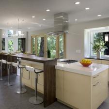 Modern Kitchen with large stainless steel ceiling hung rang hood
