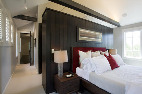 Contemporary Bedroom with stained wood wall paneling