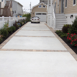 Concrete driveway with paver or stamped borders.
