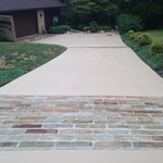 Concrete driveway with paver or stamped borders.