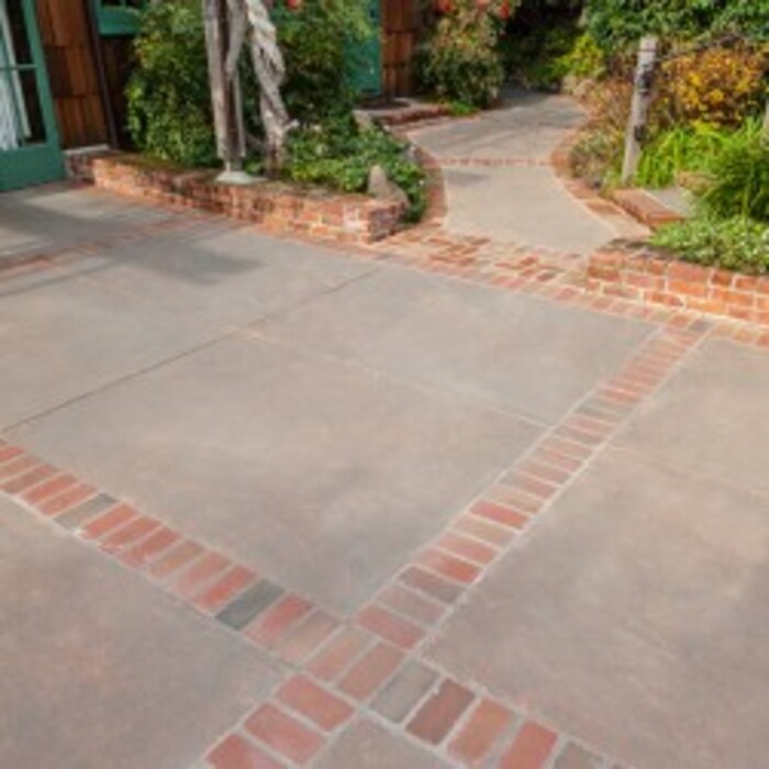 Concrete driveway with paver or stamped borders.