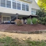 After mulch, stone wall, and grass-seeds
