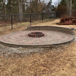 Finished patio with seating wall and fire ring