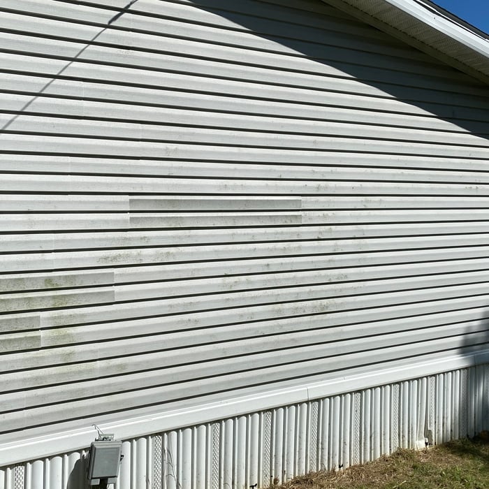 Soft washing a house