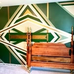 Bed frame next to custom wall