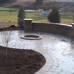 Brick paver patio with fire pit and seatwall