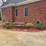 Made flower bed, laid mulch, trimmed bushes