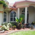 Traditional Home Exterior - Red Pink Painted Trimes Around The House