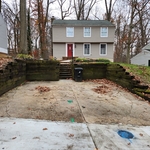 Demolition of rotten lumber retaining wall