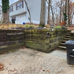 Demolition of rotten lumber retaining wall