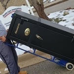 Carefully moving the safe.