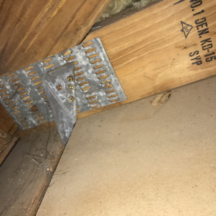 Roof to wall attachment
