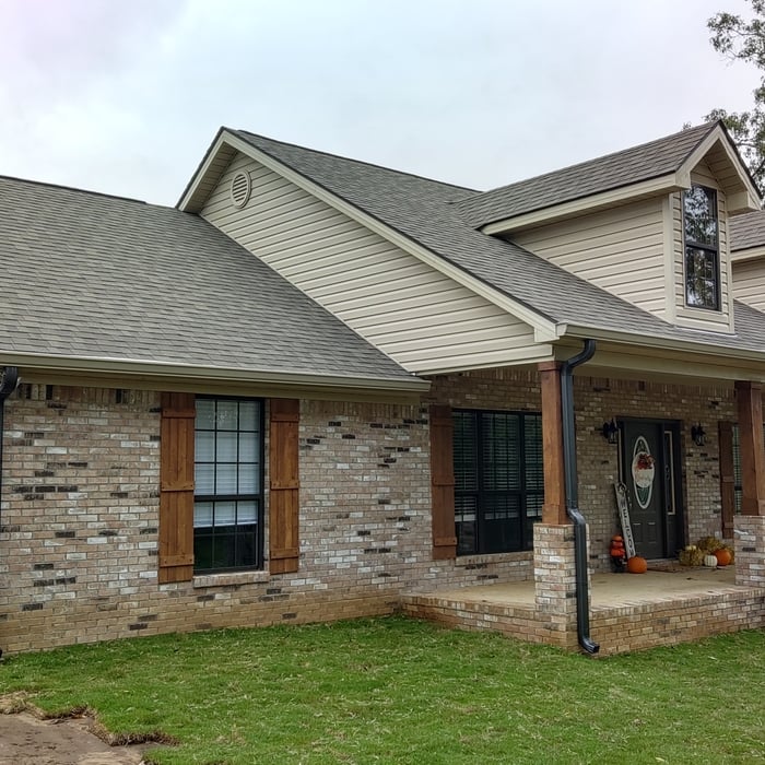Clay gutter with metallic bronze downspouts.
