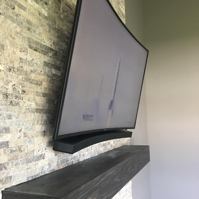 Curved tv over fireplace install