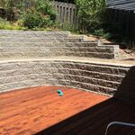 Built retaining wall with planters