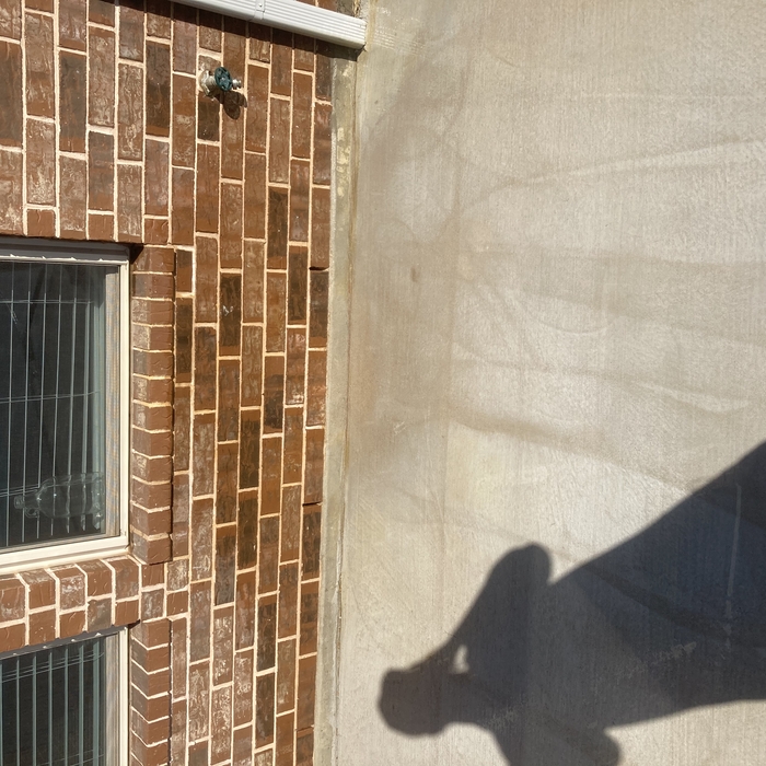 Mildew from water spout. (After)