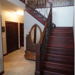 Oak stairs oversized handrail iron balusters