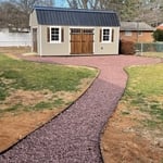 shed pad with decorative stone and walkway